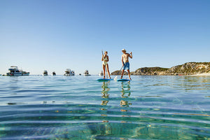 Couple stand up paddle boarding Australia