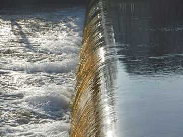 Approaching a low-head dam in a kayak.