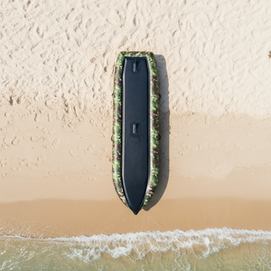 Camouflage-patterned kayak on a white background