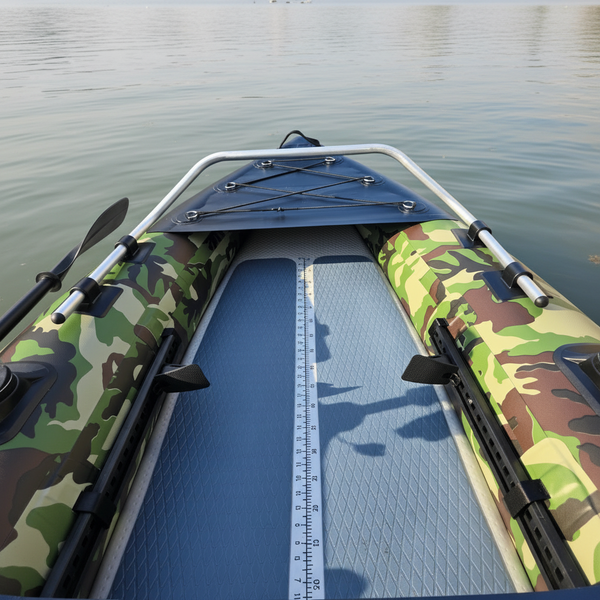 Camouflage-patterned Air Glide Angler Pro inflatable kayak with a metal frame and oars on a white background