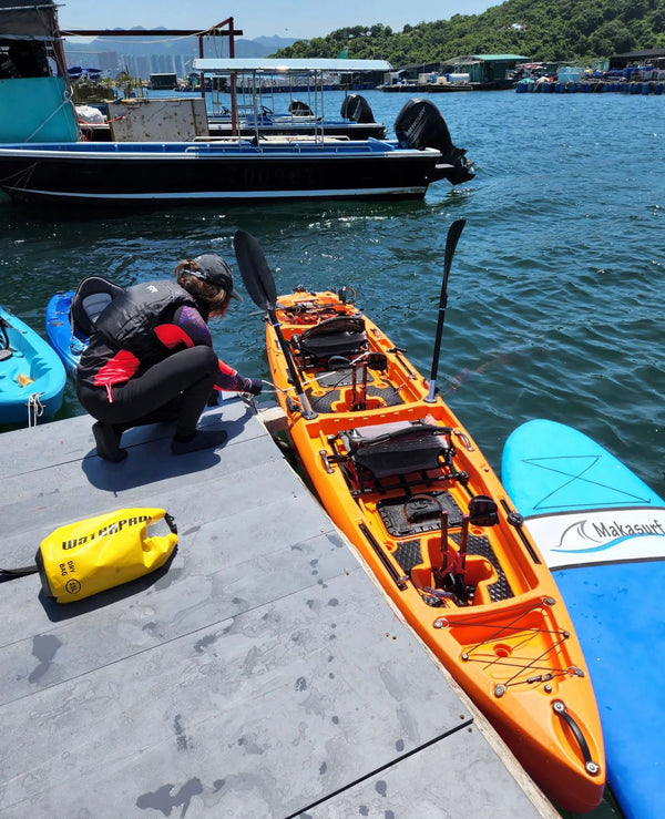 bay sports two person pedal fishing kayak orange on water